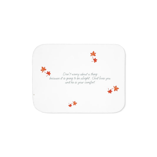 White side of blanket adorned with inspirational text, maple leaves pattern and eKuumeArt logo.