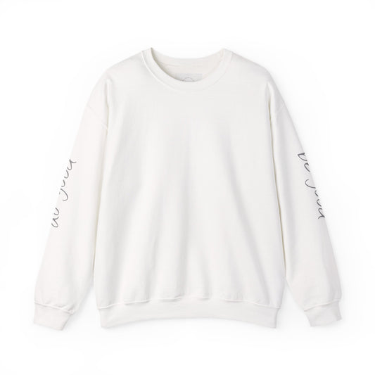 White crewneck sweatshirt with "be good, do good" text on sleeves