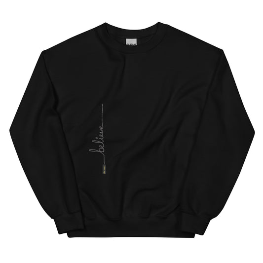 Black sweater adorned with 'Believe' handwritten text and eKuumeArt logo on torso.