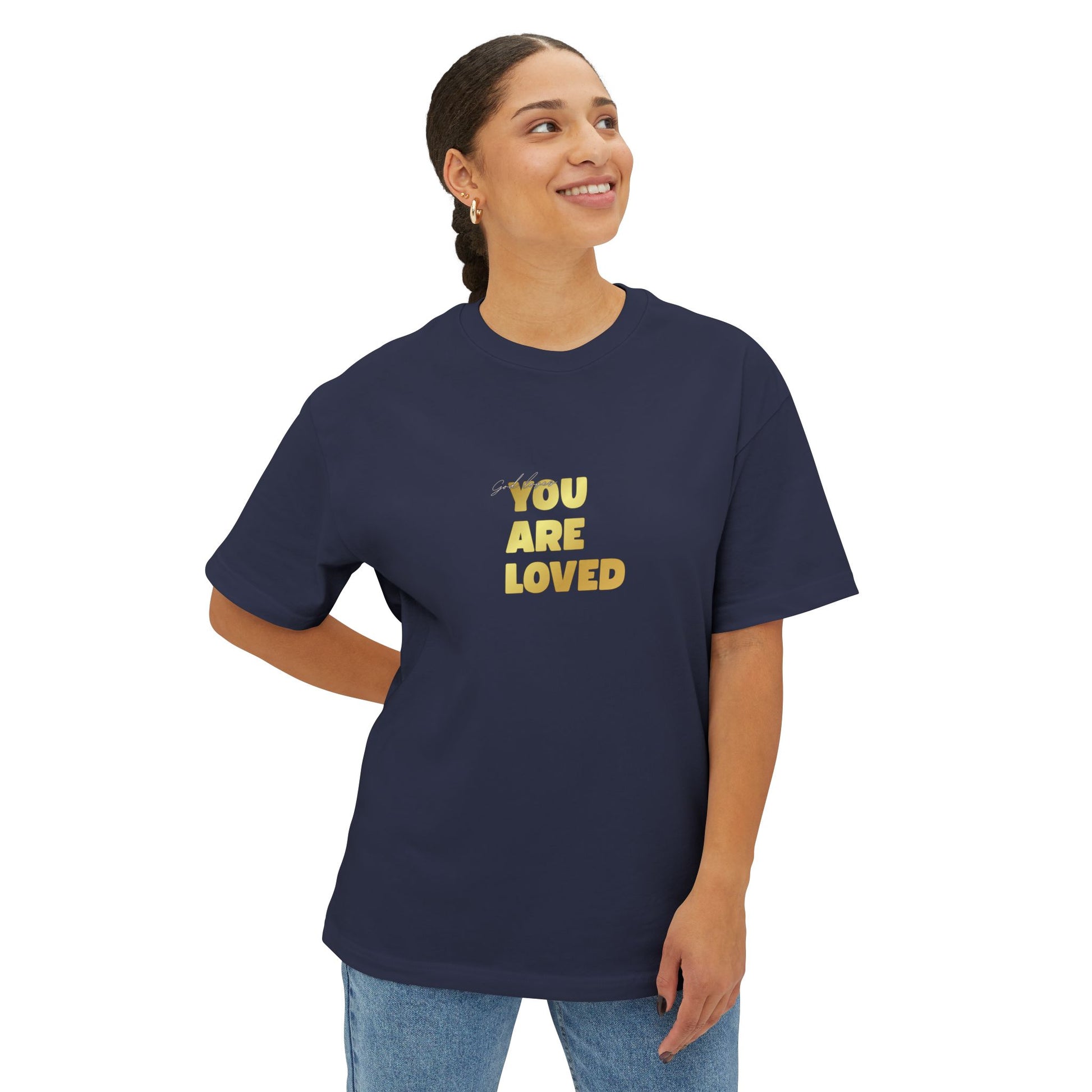 Woman wearing navy oversized boxy t-shirt adorned with 'You Are Loved' text in gold on chest.