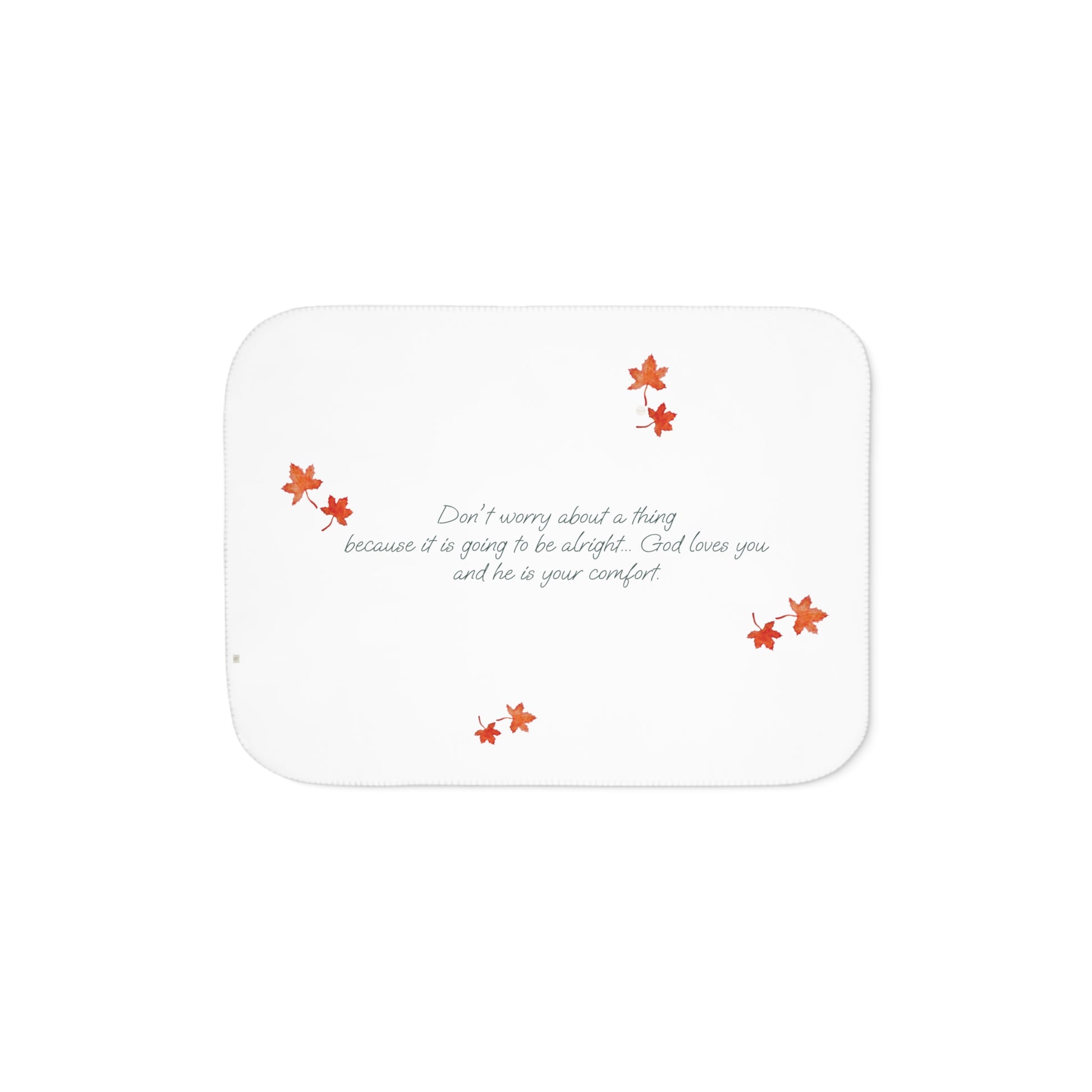 White side of blanket adorned with inspirational text, maple leaves pattern and eKuumeArt logo.
