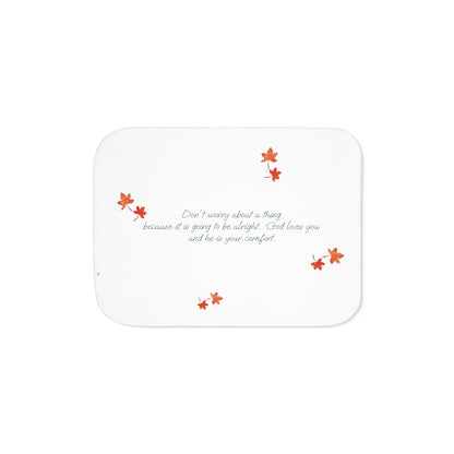White side of blanket adorned with inspirational text, maple leaves pattern and eKuumeArt logo.