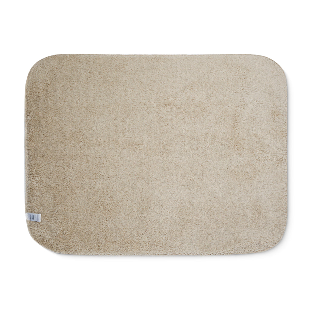 Beige sherpa side of two-coloured blanket.
