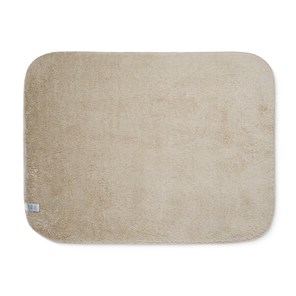 Beige sherpa side of two-coloured blanket.