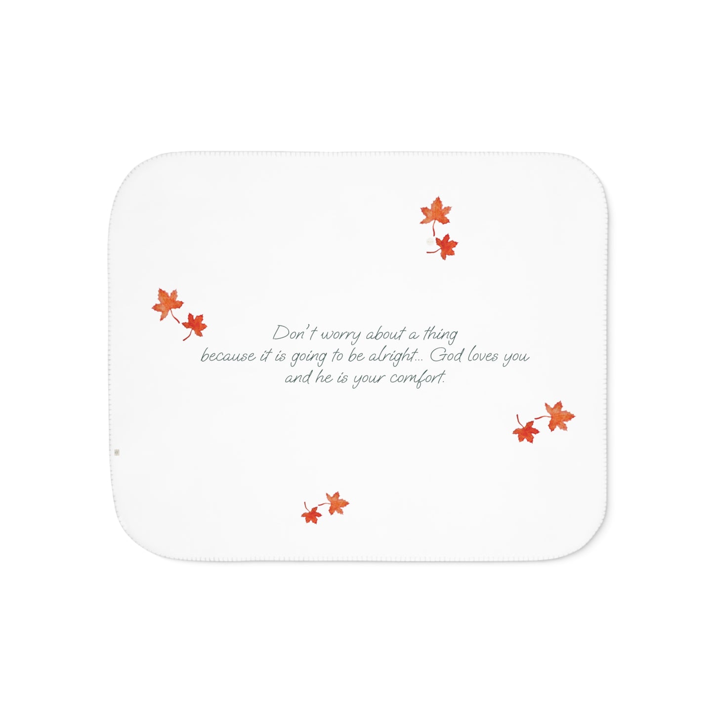 White side of blanket adorned with inspirational text, maple leaves pattern and eKuumeArt logo.