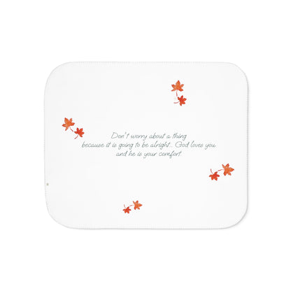 White side of blanket adorned with inspirational text, maple leaves pattern and eKuumeArt logo.