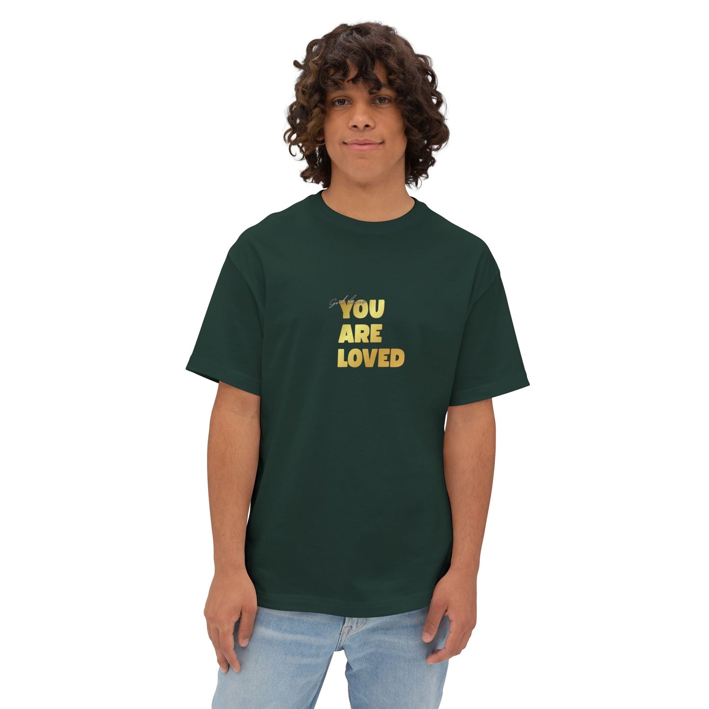 Man wearing forest green oversized boxy t-shirt adorned with 'You Are Loved' text in gold on chest.
