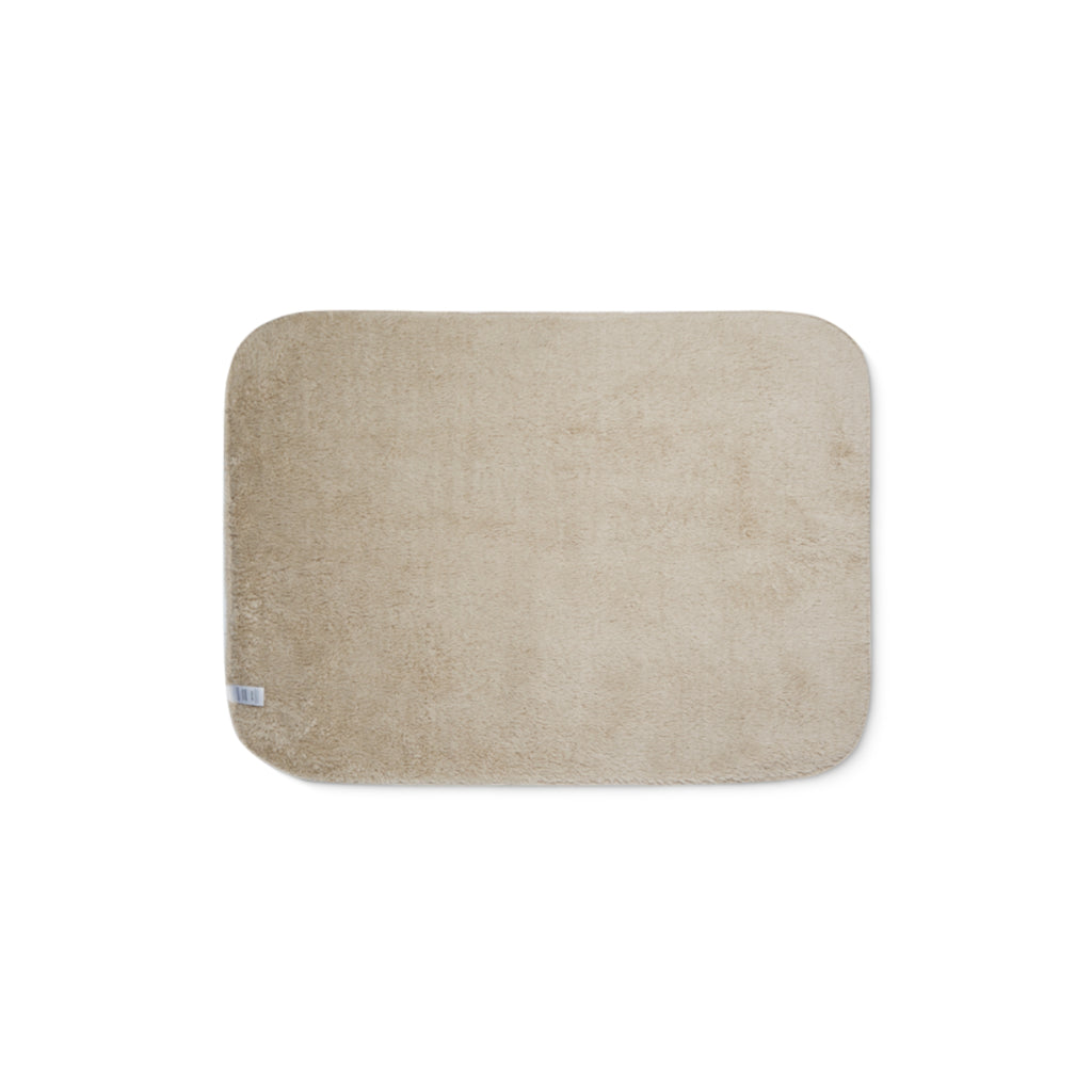 Beige sherpa side of two-coloured blanket.
