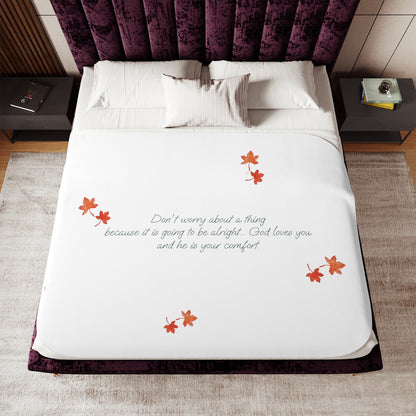 White 60"x80" blanket with inspirational text, maple leaves pattern and eKuumeArt logo – displayed on a bed in a bedroom setting.