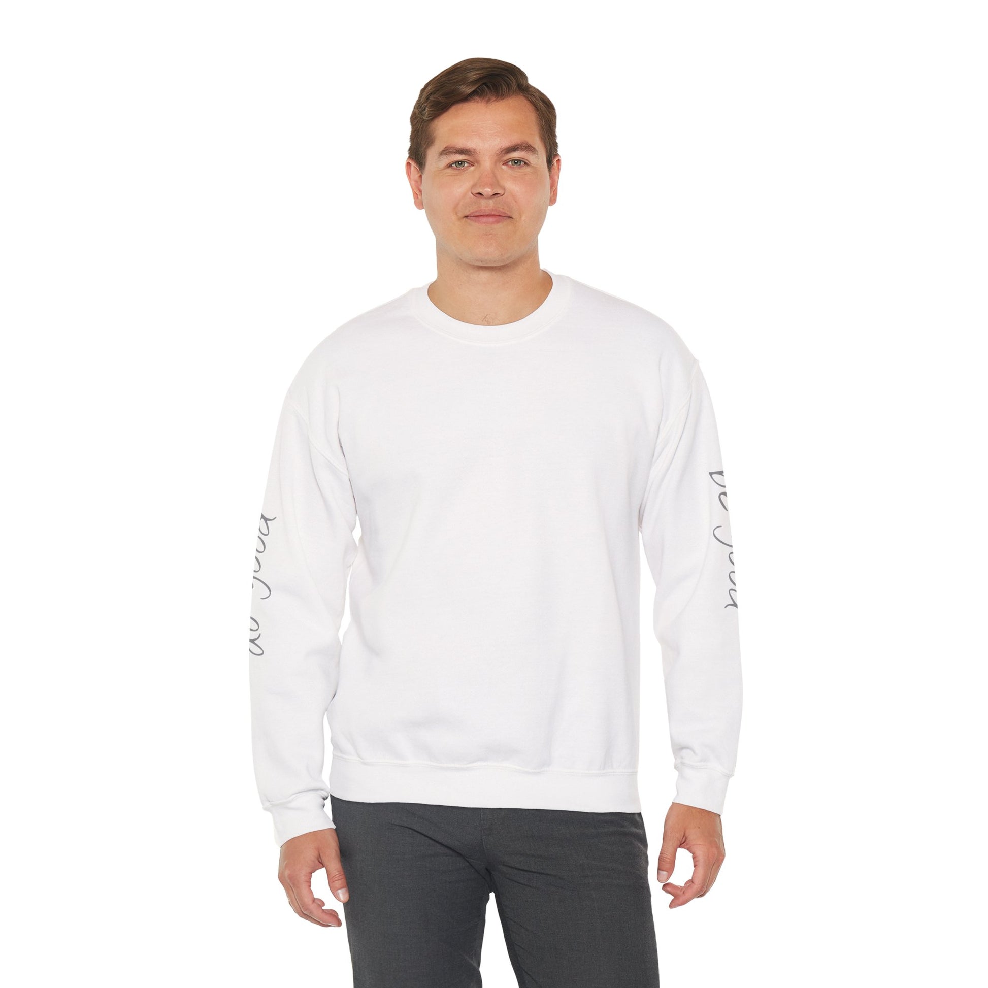 Man wearing white crewneck sweater with "be good, do good" on sleeves - front view