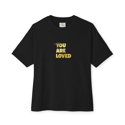 Black t-shirt adorned with 'You Are Loved' text in gold and eKuumeArt neck label.