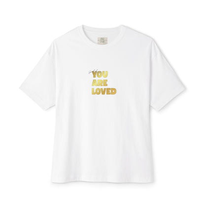 White t-shirt adorned with 'You Are Loved' text in gold and eKuumeArt neck label.