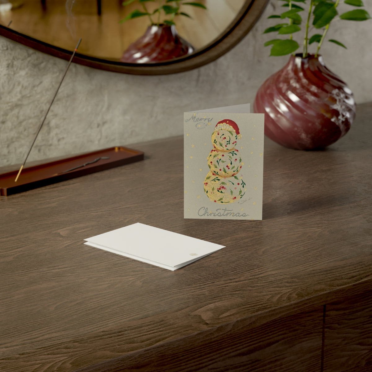 Christmas holiday card adorned with handmade painting of a vintage snowman, on a wooden surface with a calm setting – 3.5"x4.9" front and back covers | Eku ume Hope | Art.