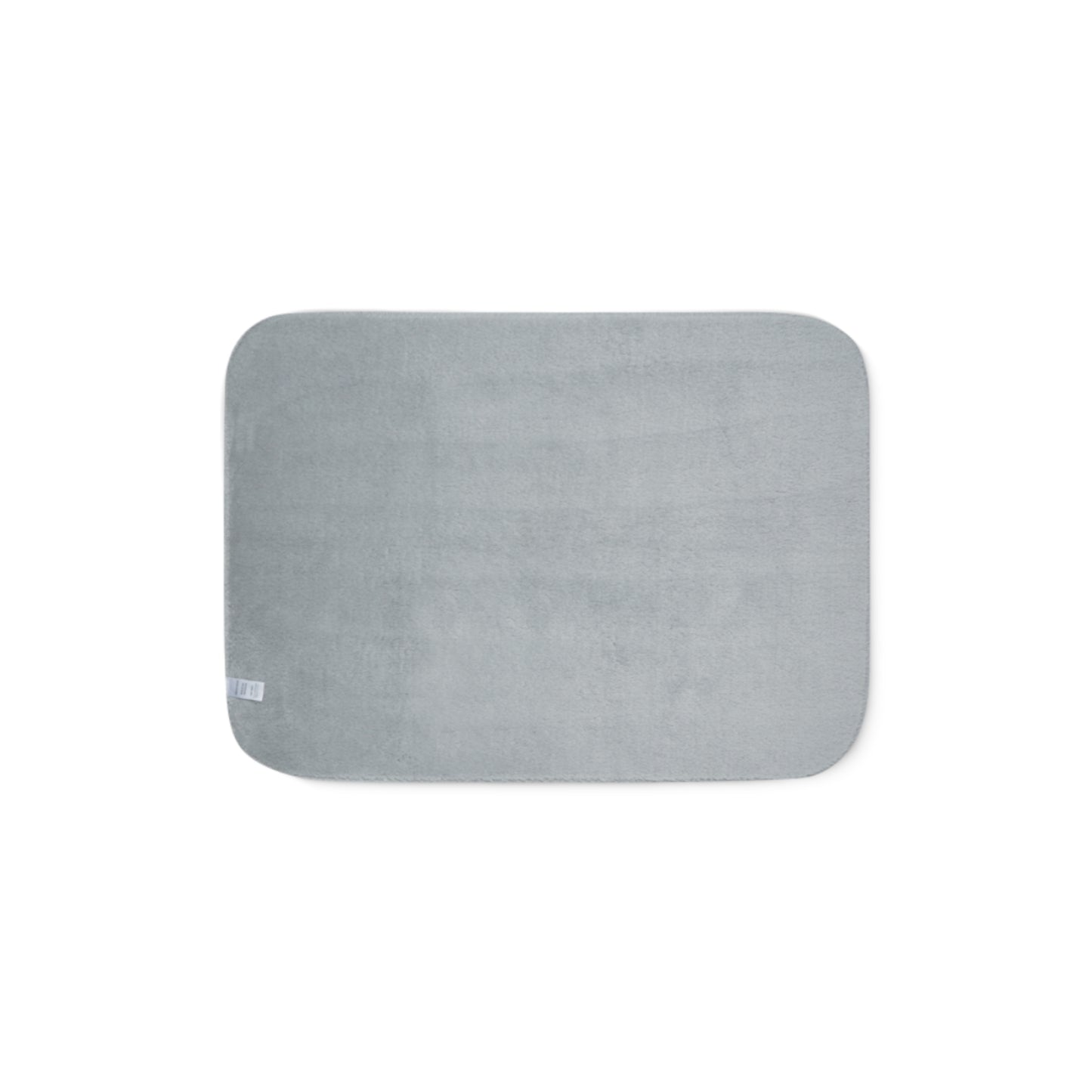 Grey sherpa side of two-coloured blanket.