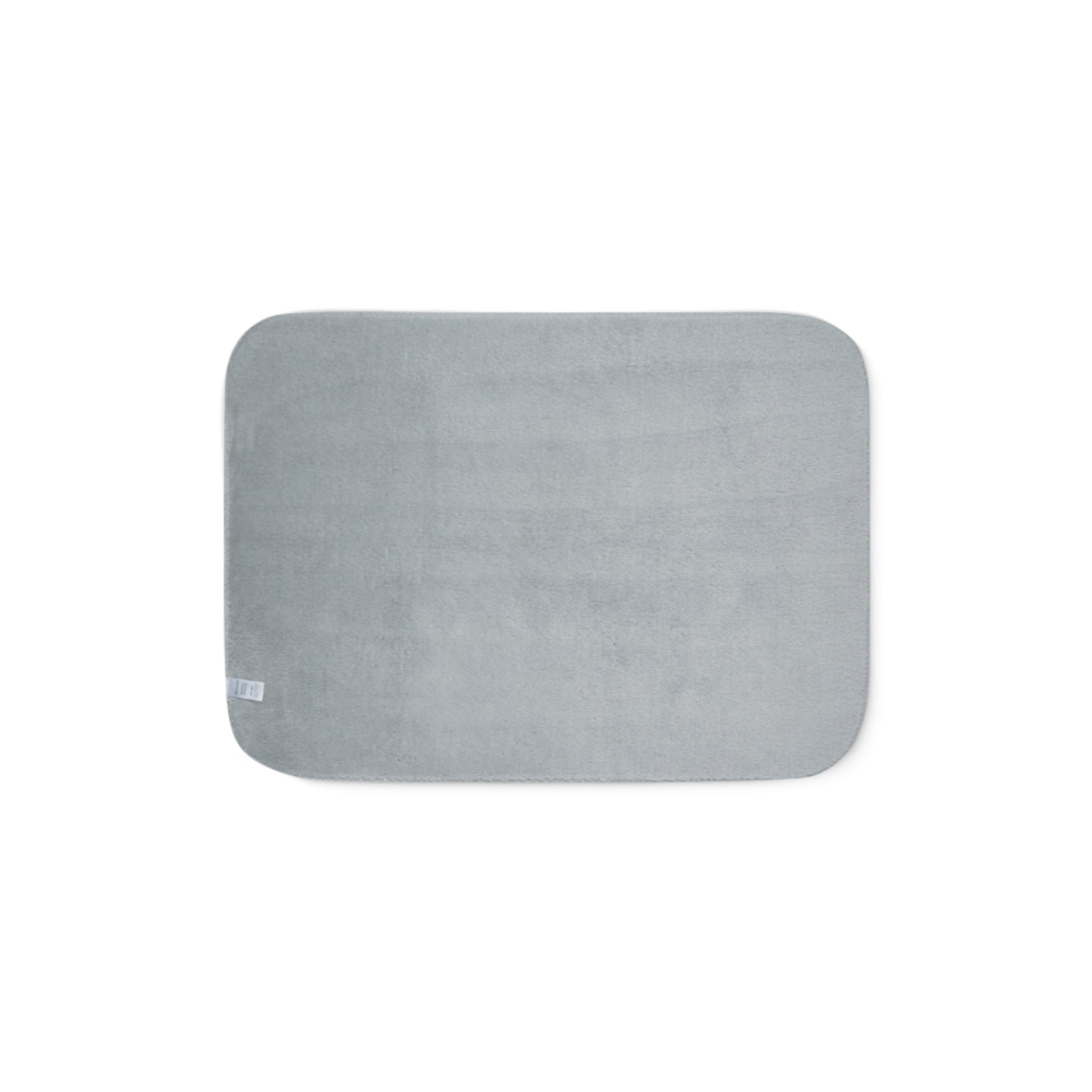 Grey sherpa side of two-coloured blanket.