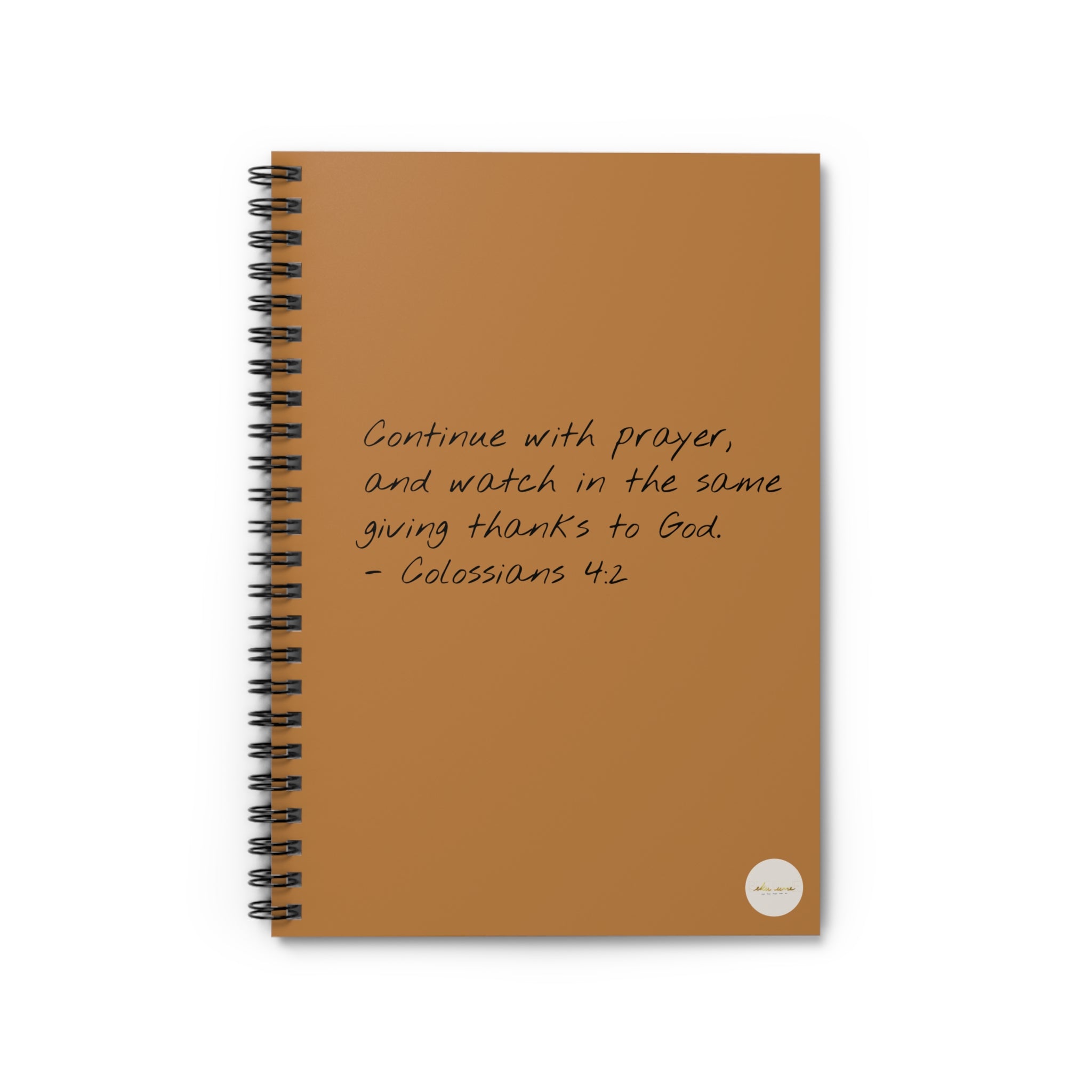 Spiral journal/notebook adorned with 'Colossians 4:2' scripture text and eKuumeArt logo on the front cover