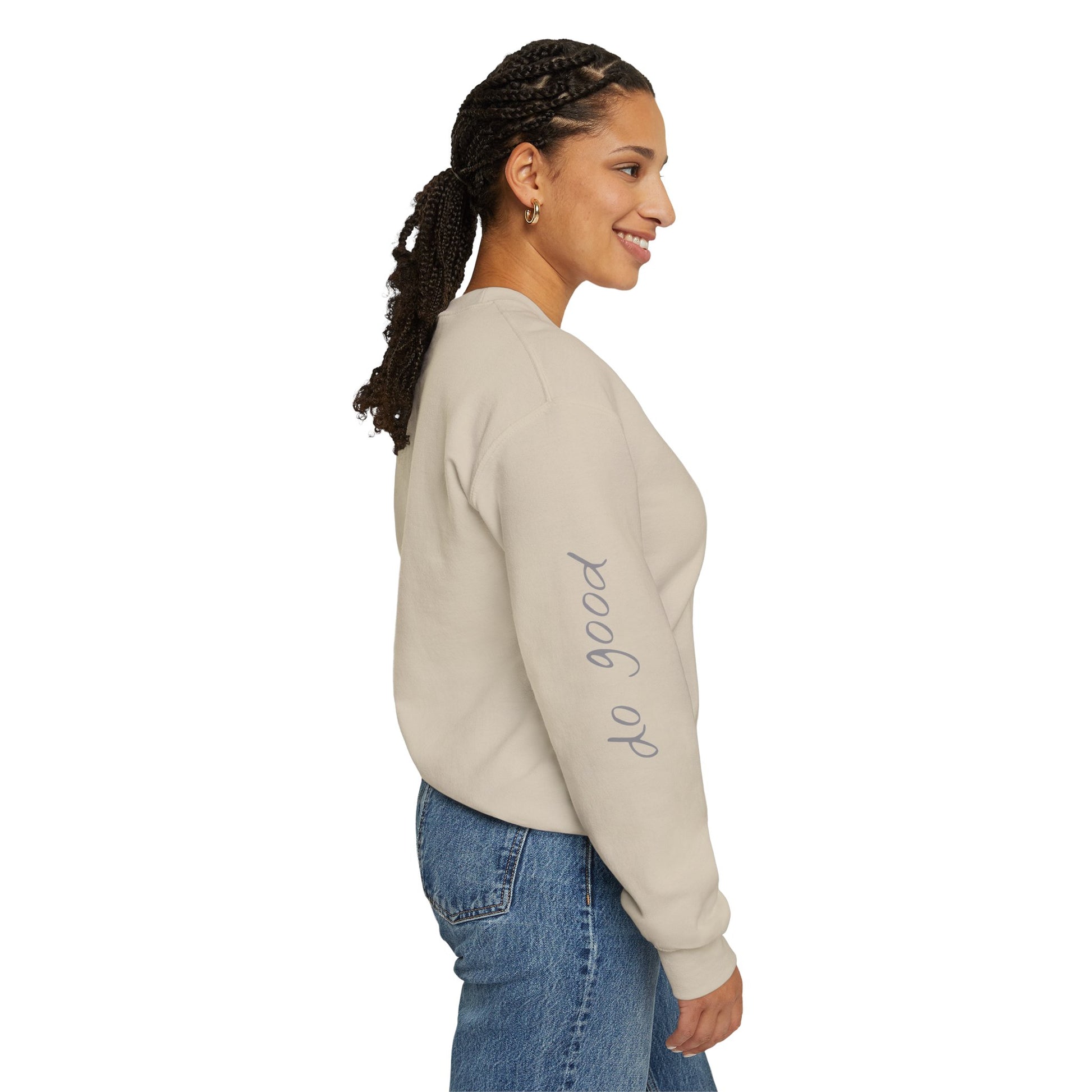Woman wearing sand crewneck sweater with "be good, do good" on sleeves - right side view