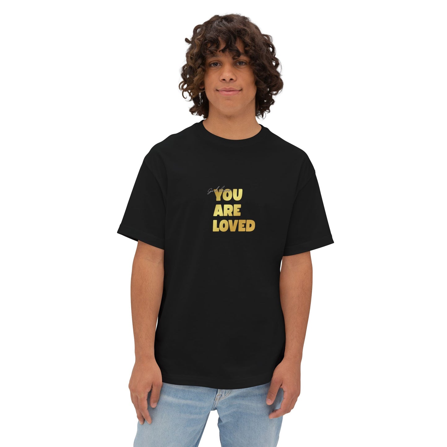 Man wearing black oversized boxy t-shirt adorned with 'You Are Loved' text in gold on chest.