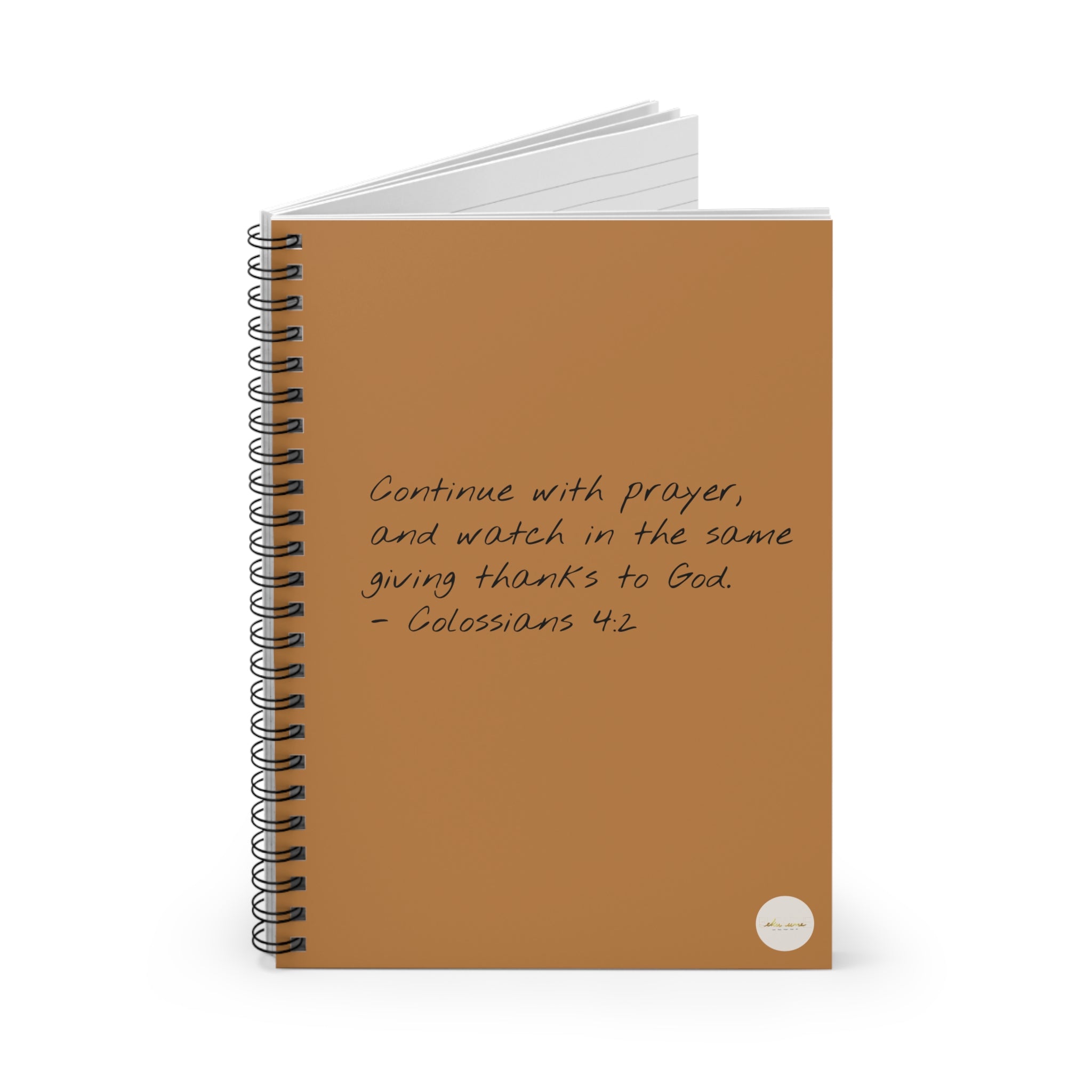 Spiral journal/notebook with 'Colossians 4:2' scripture text and eKuumeArt logo on the front cover - partially open view