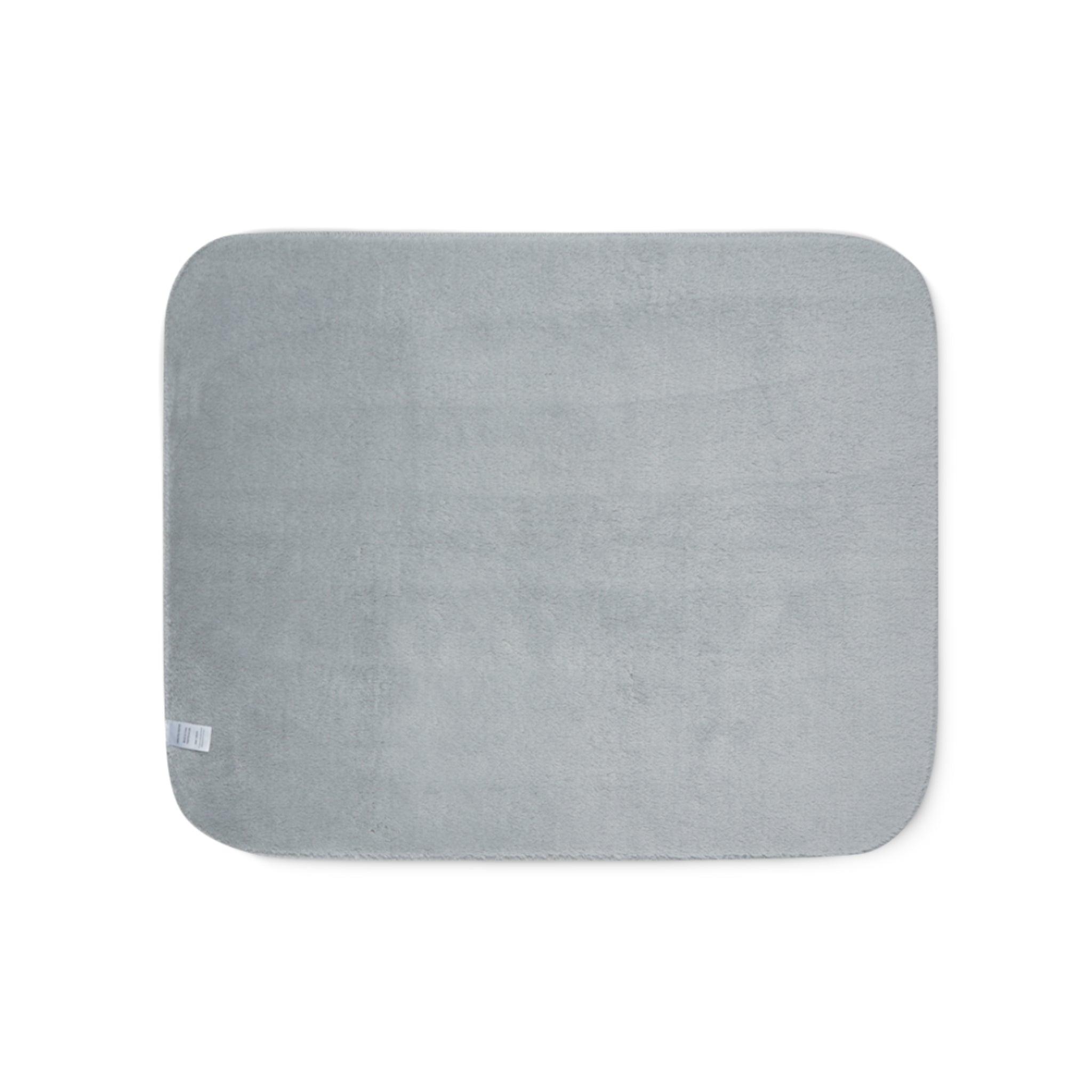 Grey sherpa side of two-coloured blanket.