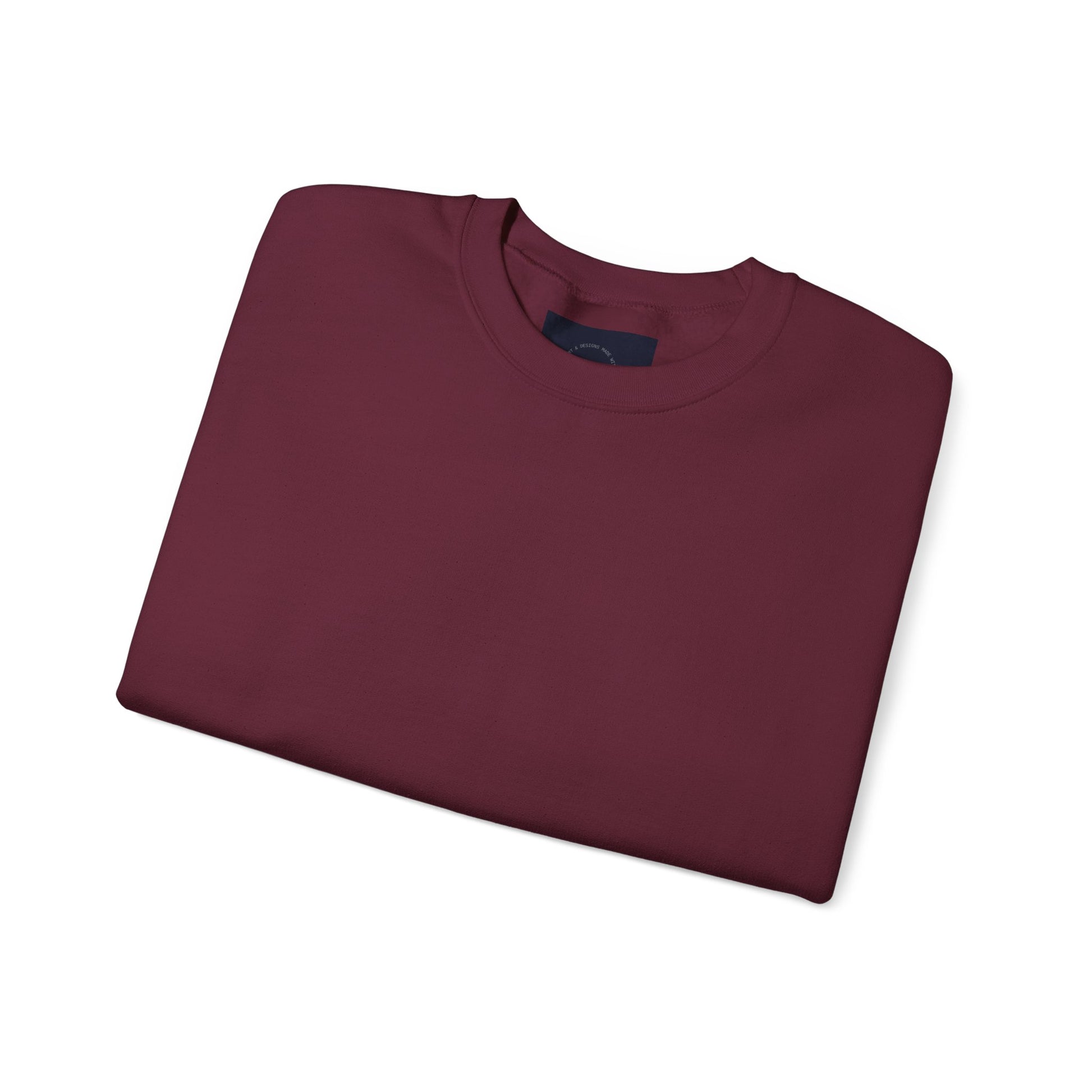 Maroon crewneck sweatshirt, folded with a peek of eKuumeArt label
