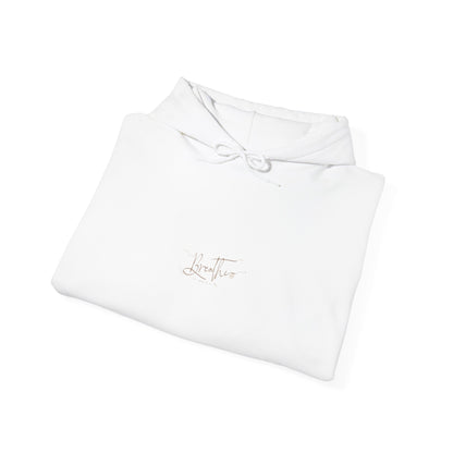 White hoodie, folded displaying 'Breathe' handwritten text on chest.