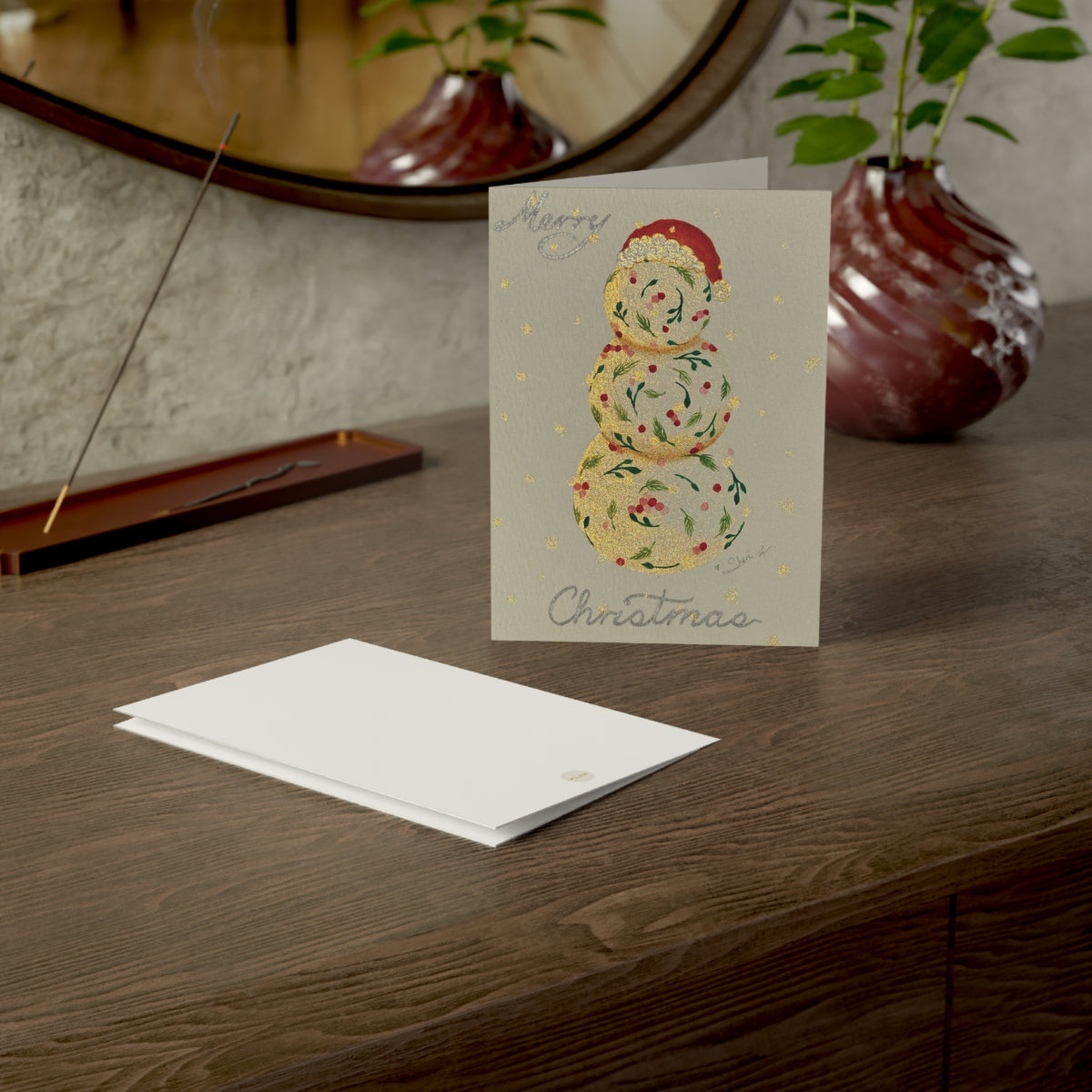 Christmas holiday card adorned with handmade painting of a vintage snowman, on a wooden surface with a calm setting – 5"x7" front and back covers | Eku ume Hope | Art.