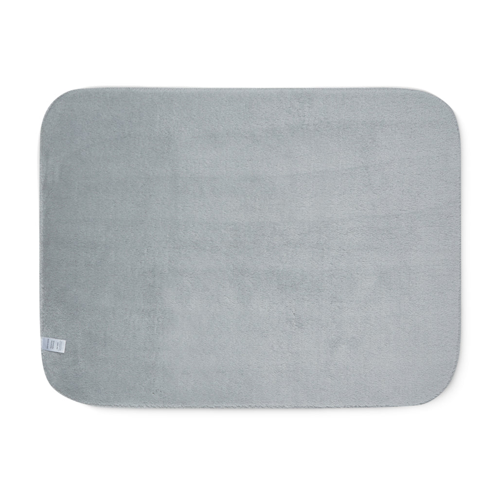 Grey sherpa side of two-coloured blanket.