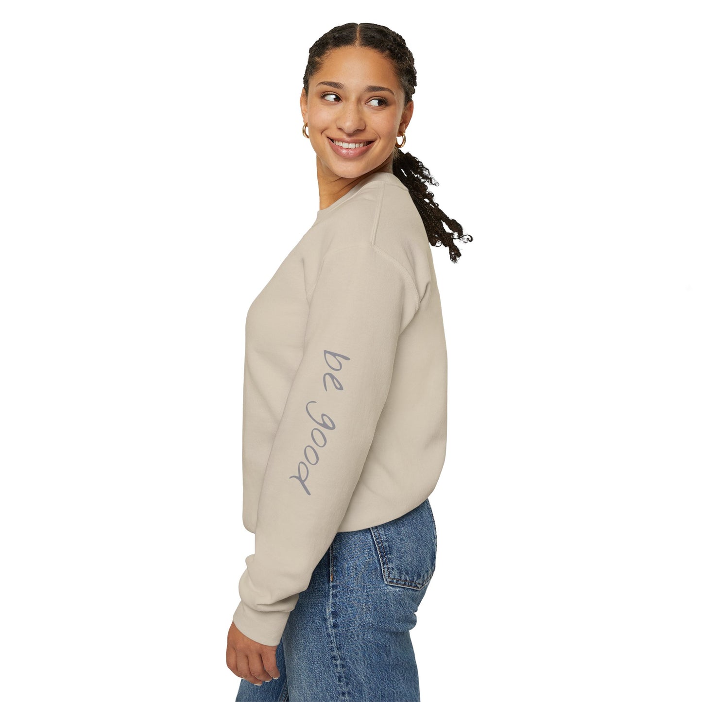 Woman wearing sand crewneck sweater with "be good, do good" on sleeves - left side view