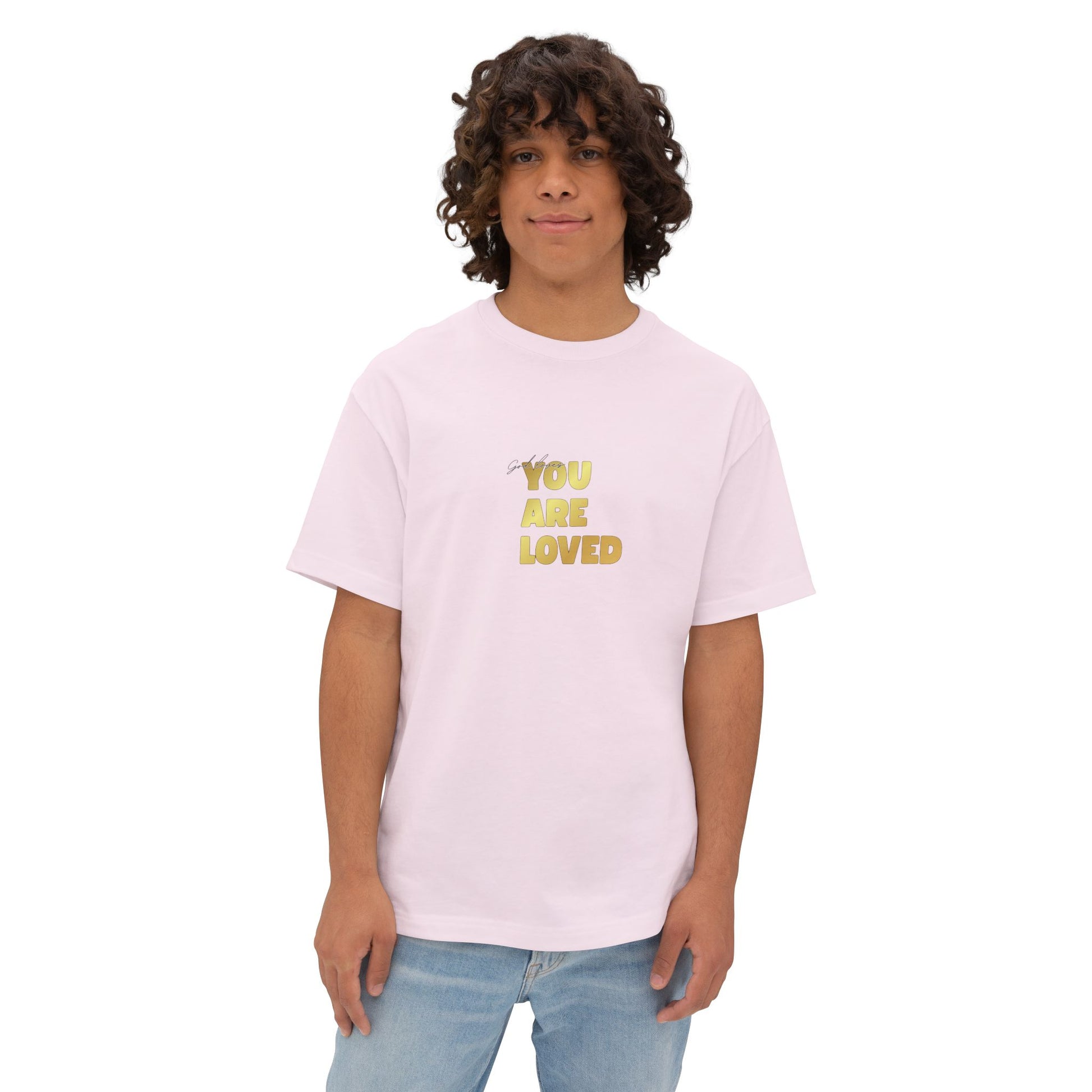 Man wearing soft pink oversized boxy t-shirt adorned with 'You Are Loved' text in gold on chest.