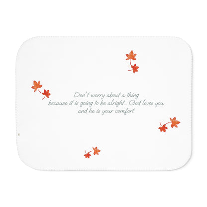 White side of blanket adorned with inspirational text, maple leaves pattern and eKuumeArt logo.