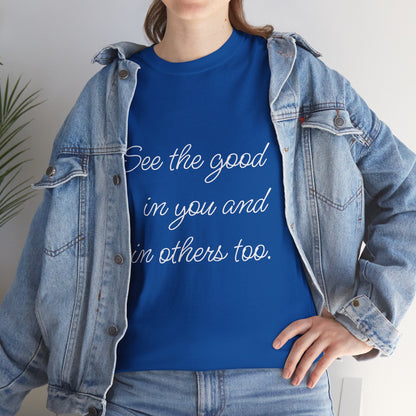 Woman wearing a royal blue heavy cotton t-shirt with motivational quote text, styled with a denim jacket - closeup view.