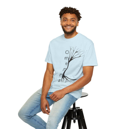 Man seated on stool wearing chambray tshirt with hand-drawn tree, 'Omemma' text and eKuumeArt logo on torso.
