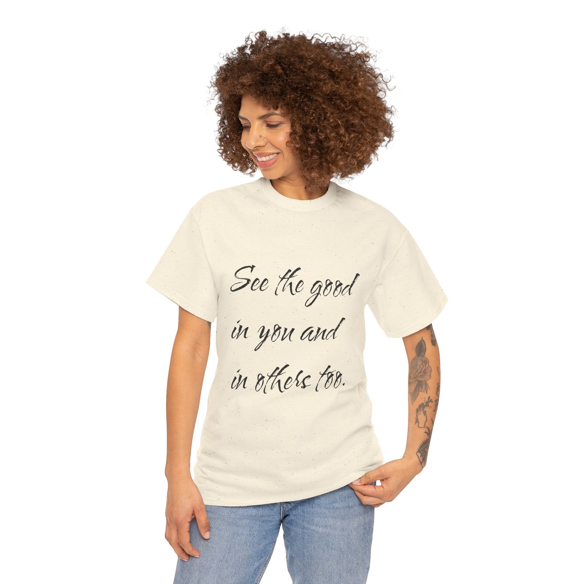 Woman wearing a natural/beige heavy cotton t-shirt with ‘See the good…’ motivational quote text.