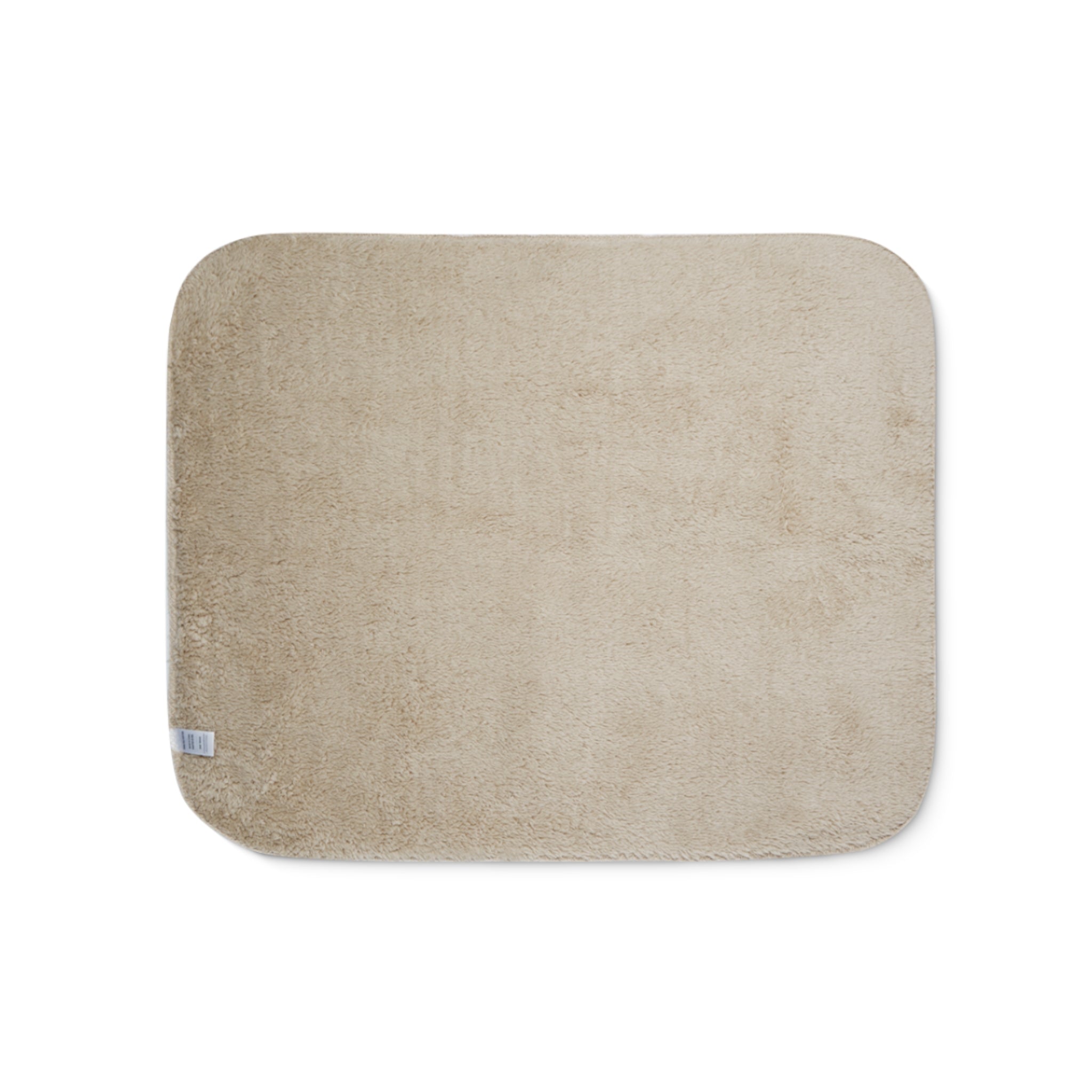 Beige sherpa side of two-coloured blanket.