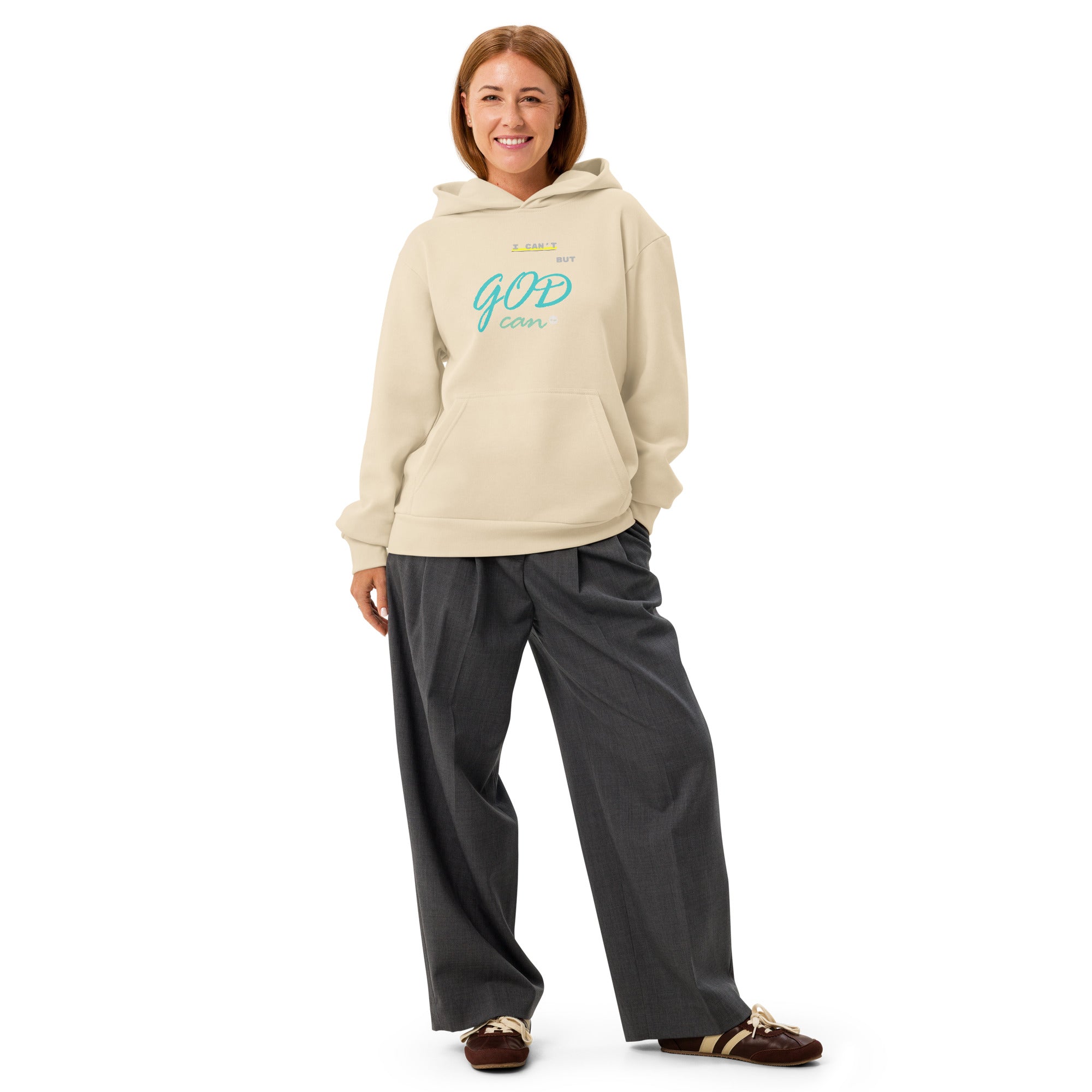 Woman wearing sandshell hoodie with 'I can't but God can' text on chest.