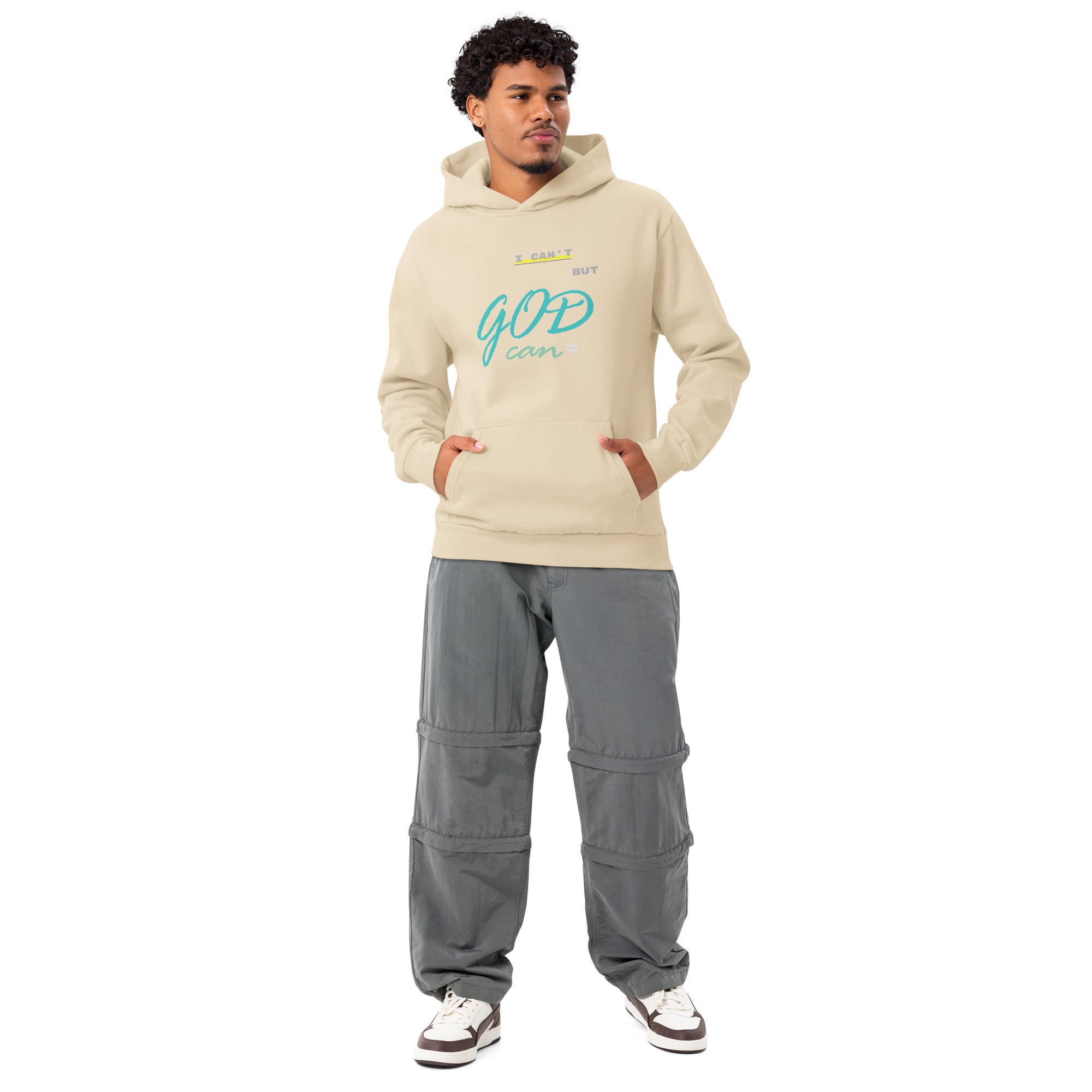 Man wearing sandshell hoodie with 'I can't but God can' text on chest.
