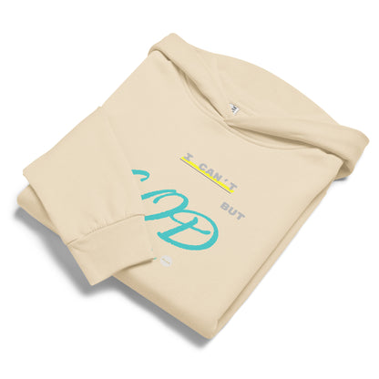 Sandshell hoodie, folded displaying 'I can't but God can' text and eKuumeArt logo on chest – one sleeve fold covering part of text.