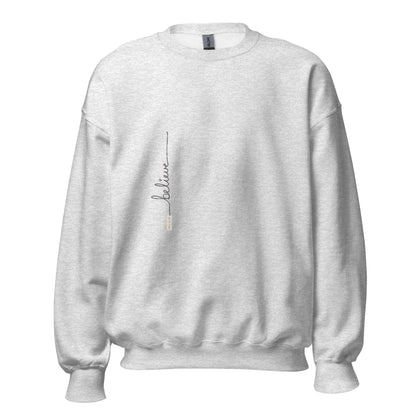 Ash sweater adorned with 'Believe' handwritten text and eKuumeArt logo on torso.