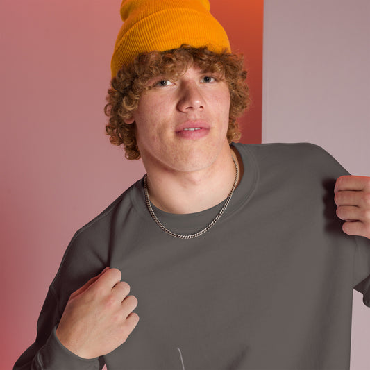Man wearing an orange beanie and charcoal sweater with glimpse of 'Believe' handwritten text line - closeup view, featuring a pink and white room setting
