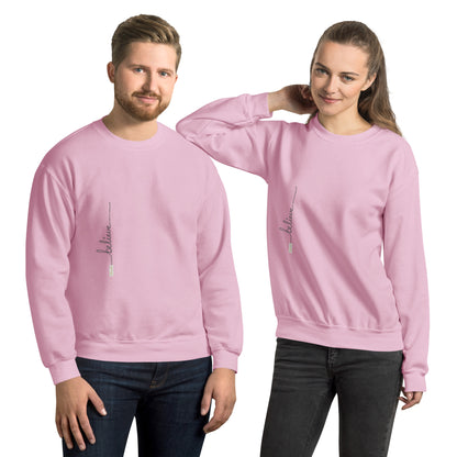 Man and woman wearing light pink sweaters with 'Believe' handwritten text and eKuumeArt logo on torso – front view.