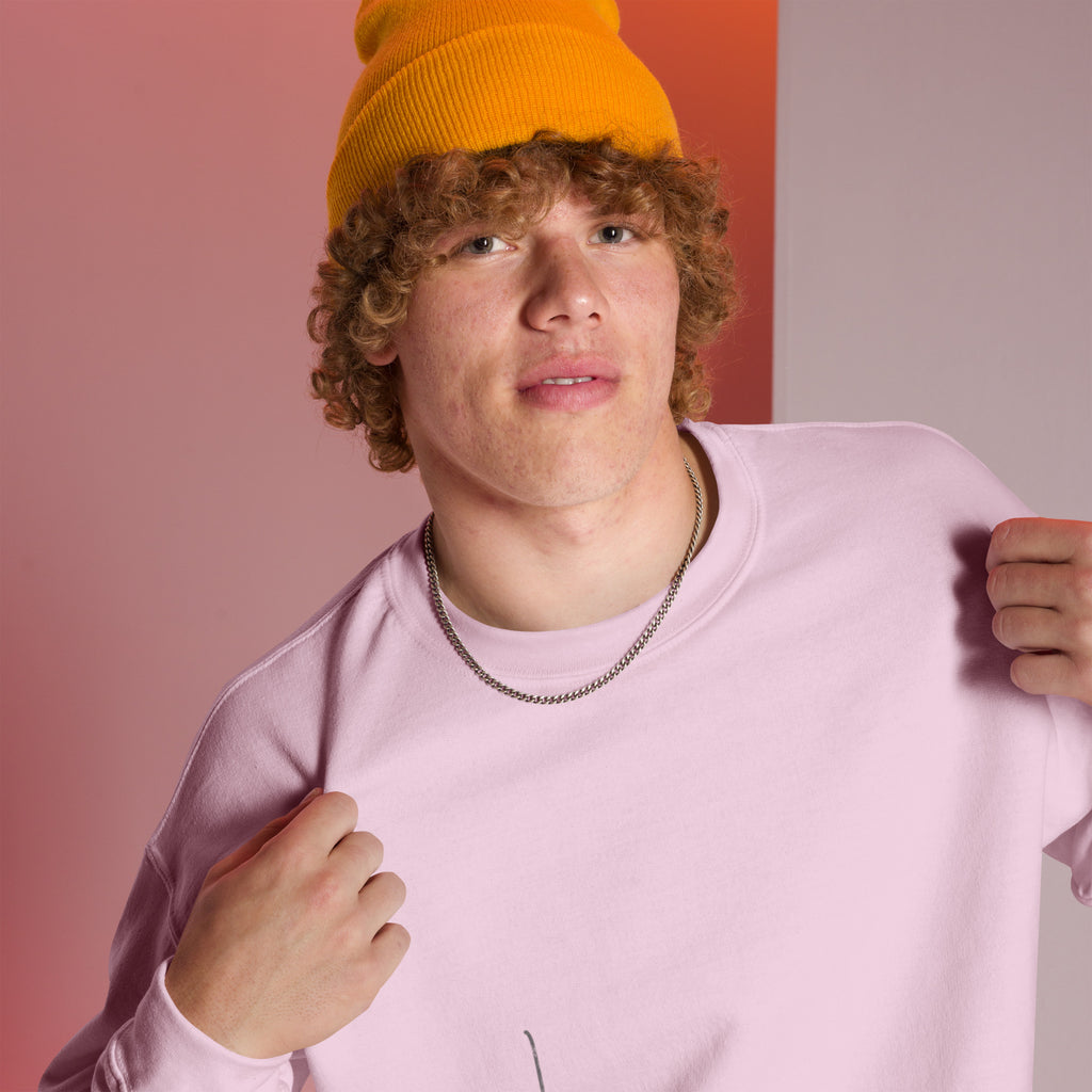 Man wearing an orange beanie and light pink sweater with glimpse of 'Believe' handwritten text line – closeup view, featuring a pink and white room setting.