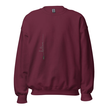 Maroon sweater adorned with 'Believe' handwritten text and eKuumeArt logo on torso.