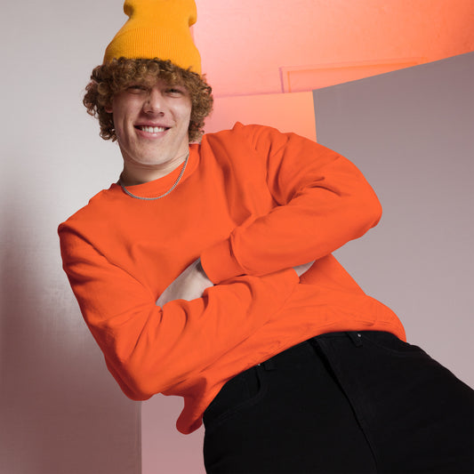 Man wearing orange beanie and orange sweater - closeup view, featuring a peach and grey room setting