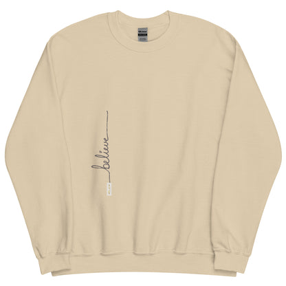 Sand sweater adorned with 'Believe' handwritten text and eKuumeArt logo on torso.