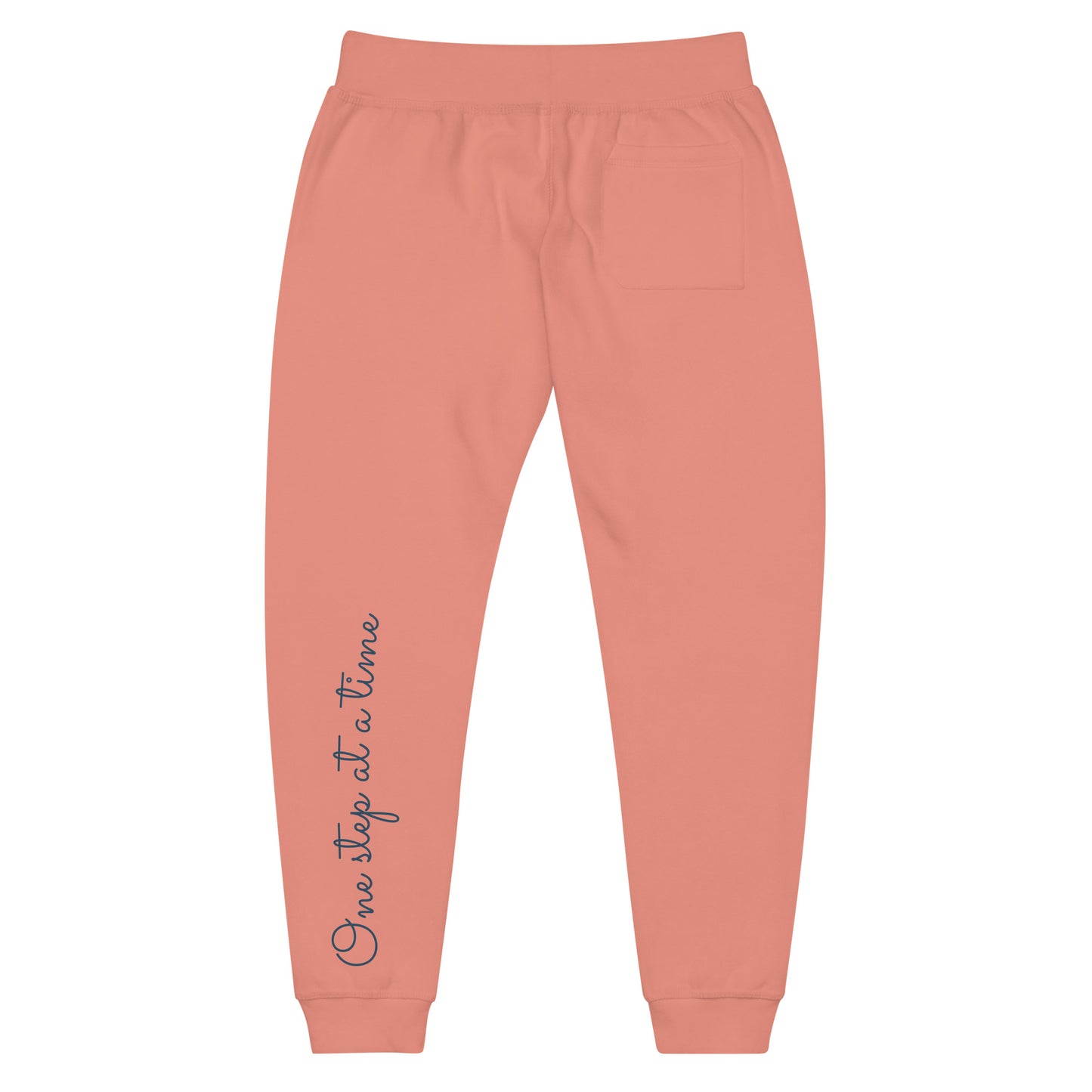 Dusty rose sweatpants adorned with 'One step at a time' text on back left leg.