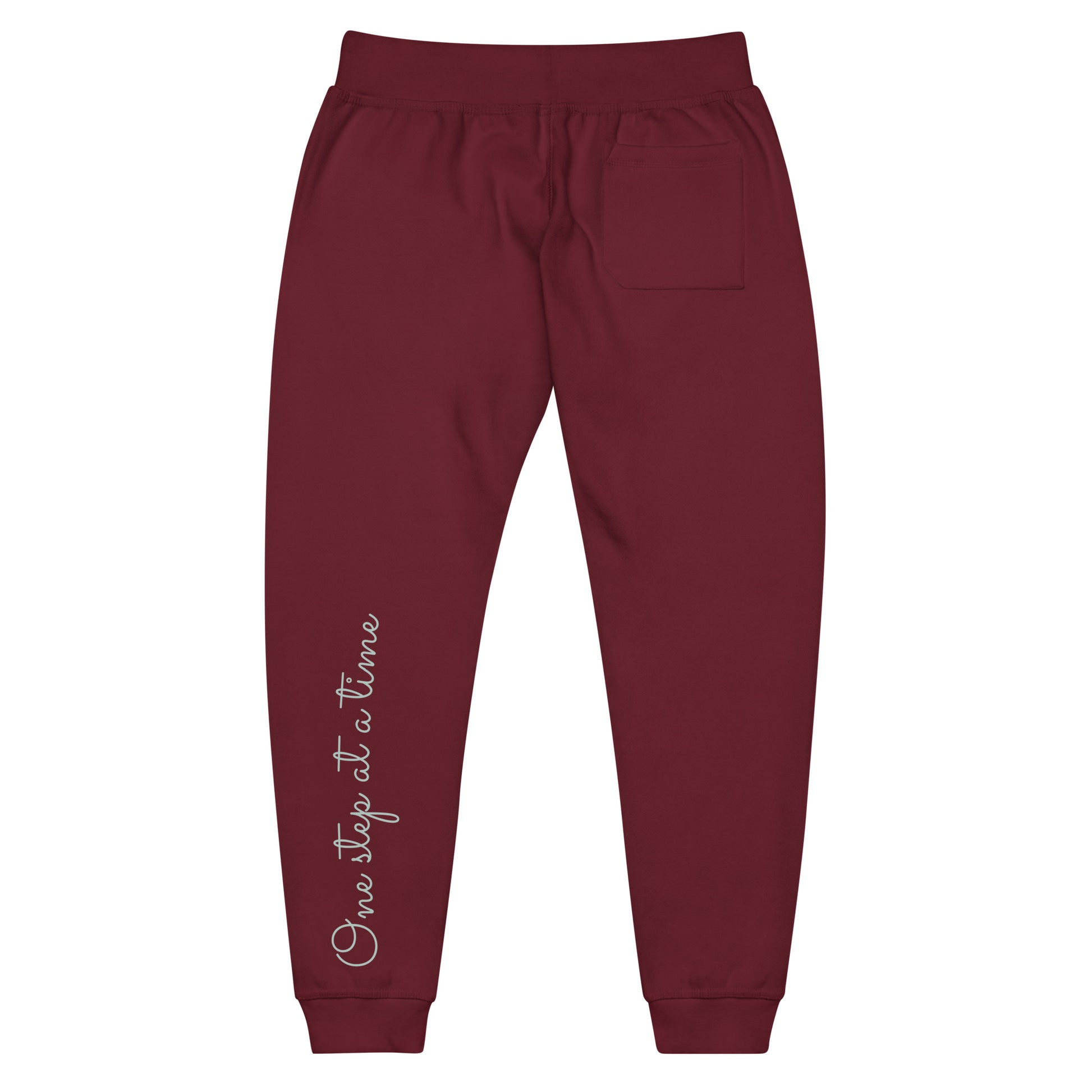 Maroon sweatpants adorned with 'One step at a time' text on back left leg.