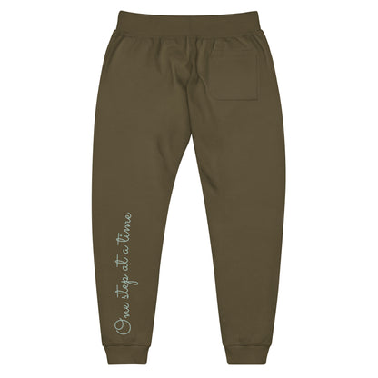 Military Green sweatpants adorned with 'One step at a time' text on back left leg.
