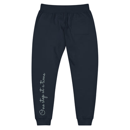 Navy Blazer sweatpants adorned with 'One step at a time' text on back left leg.