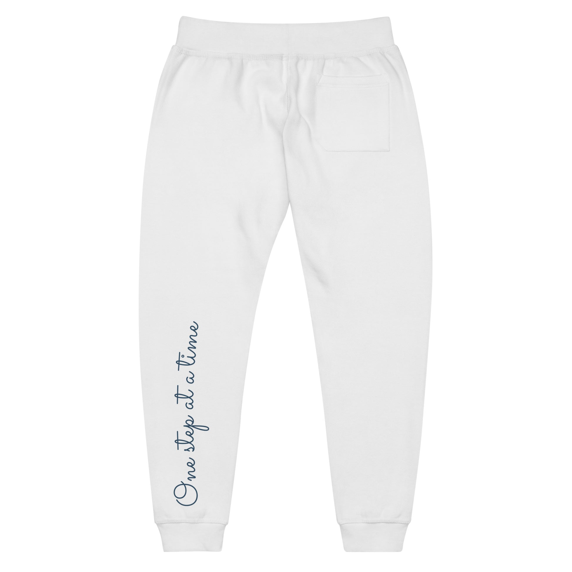 White sweatpants adorned with 'Walking by faith' text on back left leg.